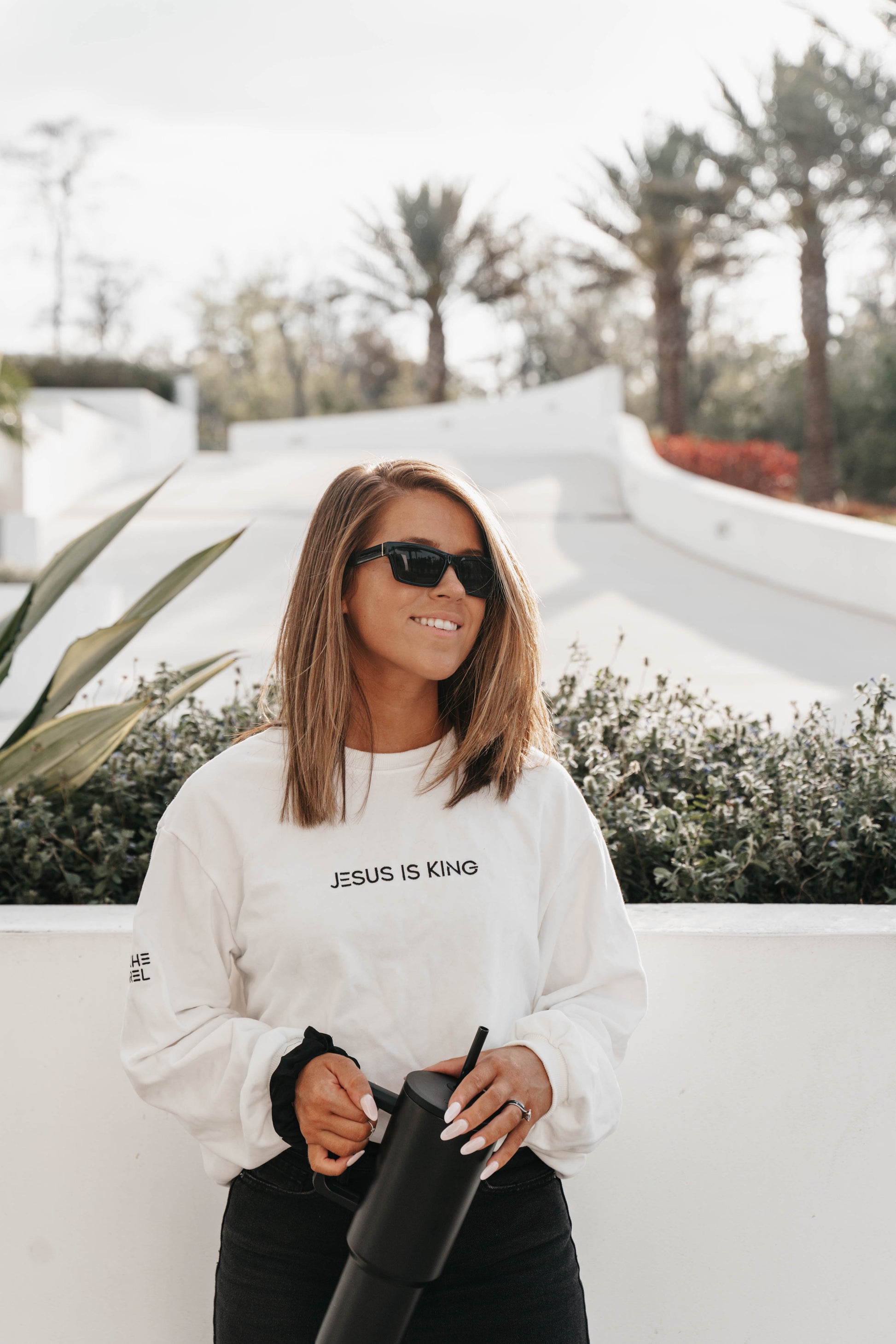 Woman in “Jesus Is King” long sleeve shirt – clean faith-based fashion