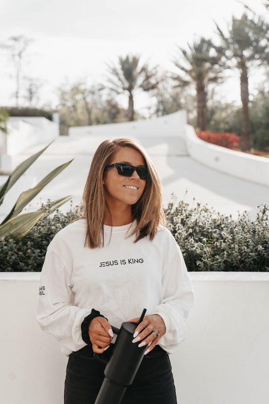 Woman in “Jesus Is King” long sleeve shirt – clean faith-based fashion