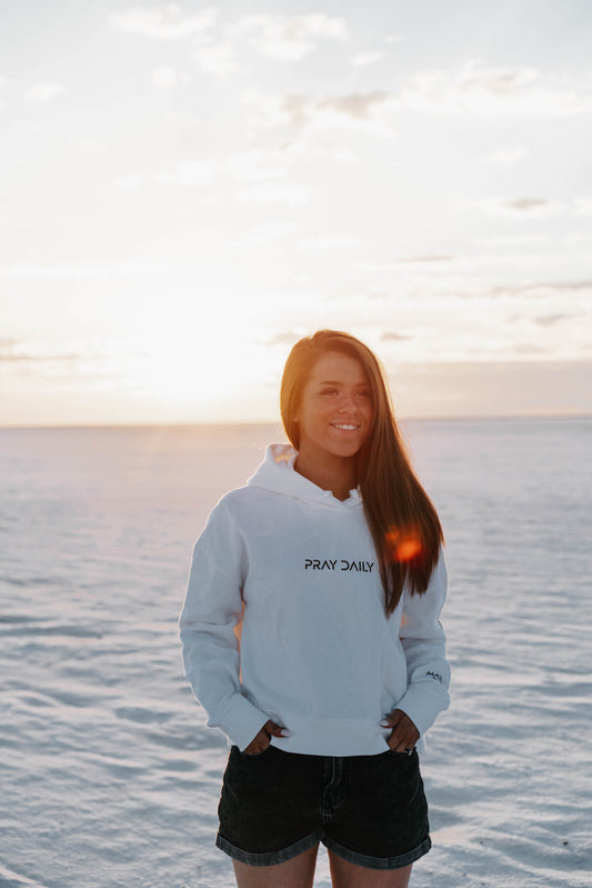 Woman in “Pray Daily” grey hoodie – Christian spiritual reminder
