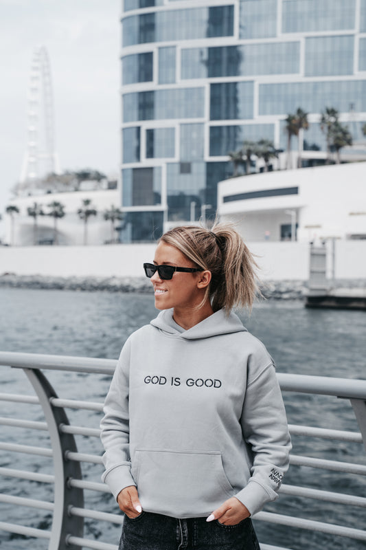 Woman wearing grey “God is Good” Christian hoodie – Avaoche Apparel